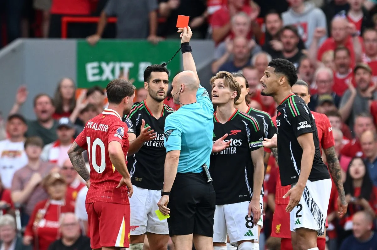 Anthony Taylor shows a red card to Arsenal's Mikel Merino their clash against Liverpool last year