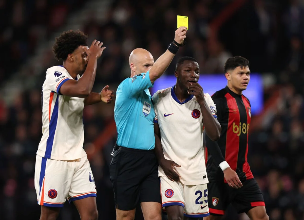Anthony Taylor issues one of his 14 yellow cards during a match between Chelsea and Bournemouth