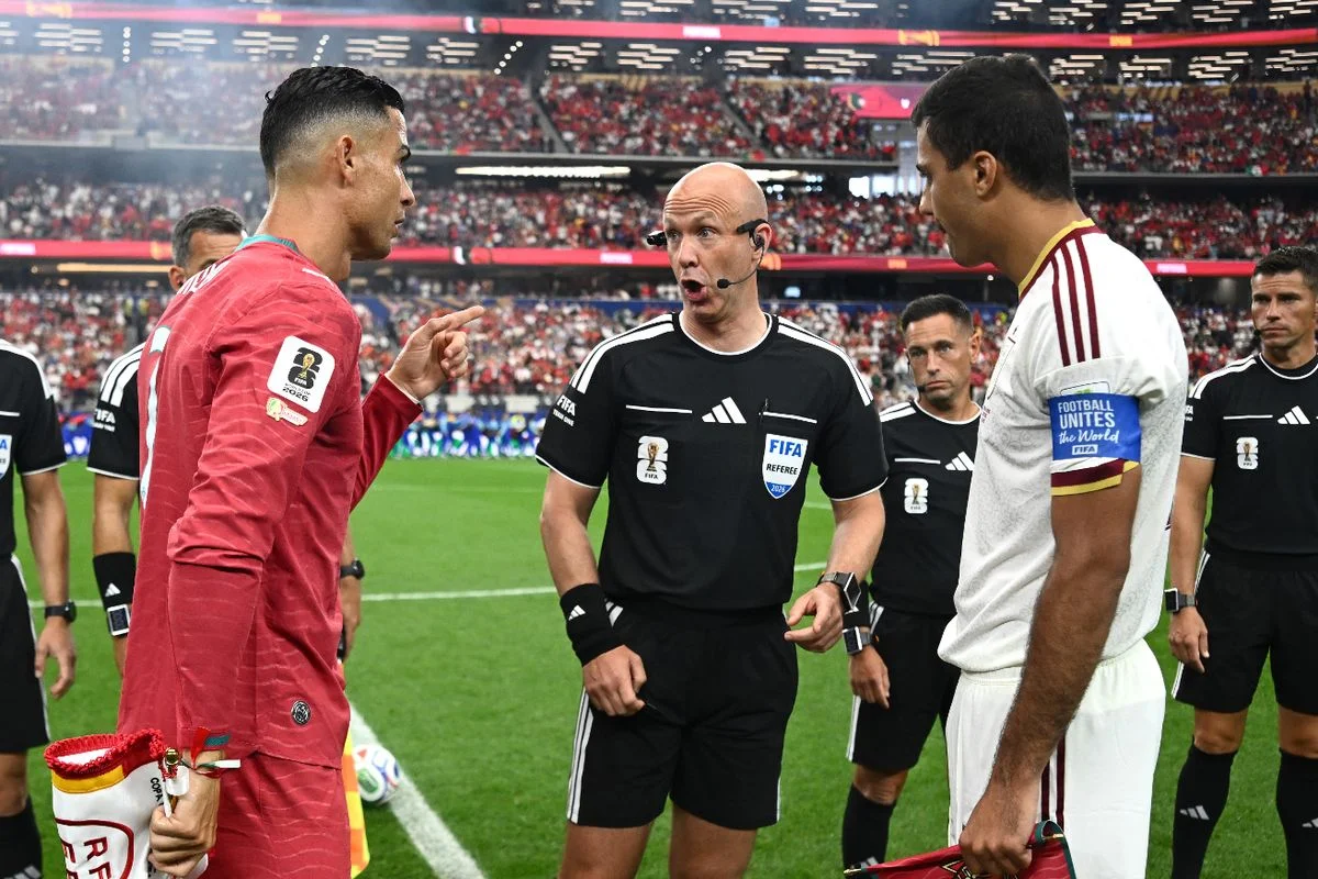 Referee Anthony Taylor conducts the coin toss between Cristiano Ronaldo #7 of Portugal and Rodri #16 of Spain